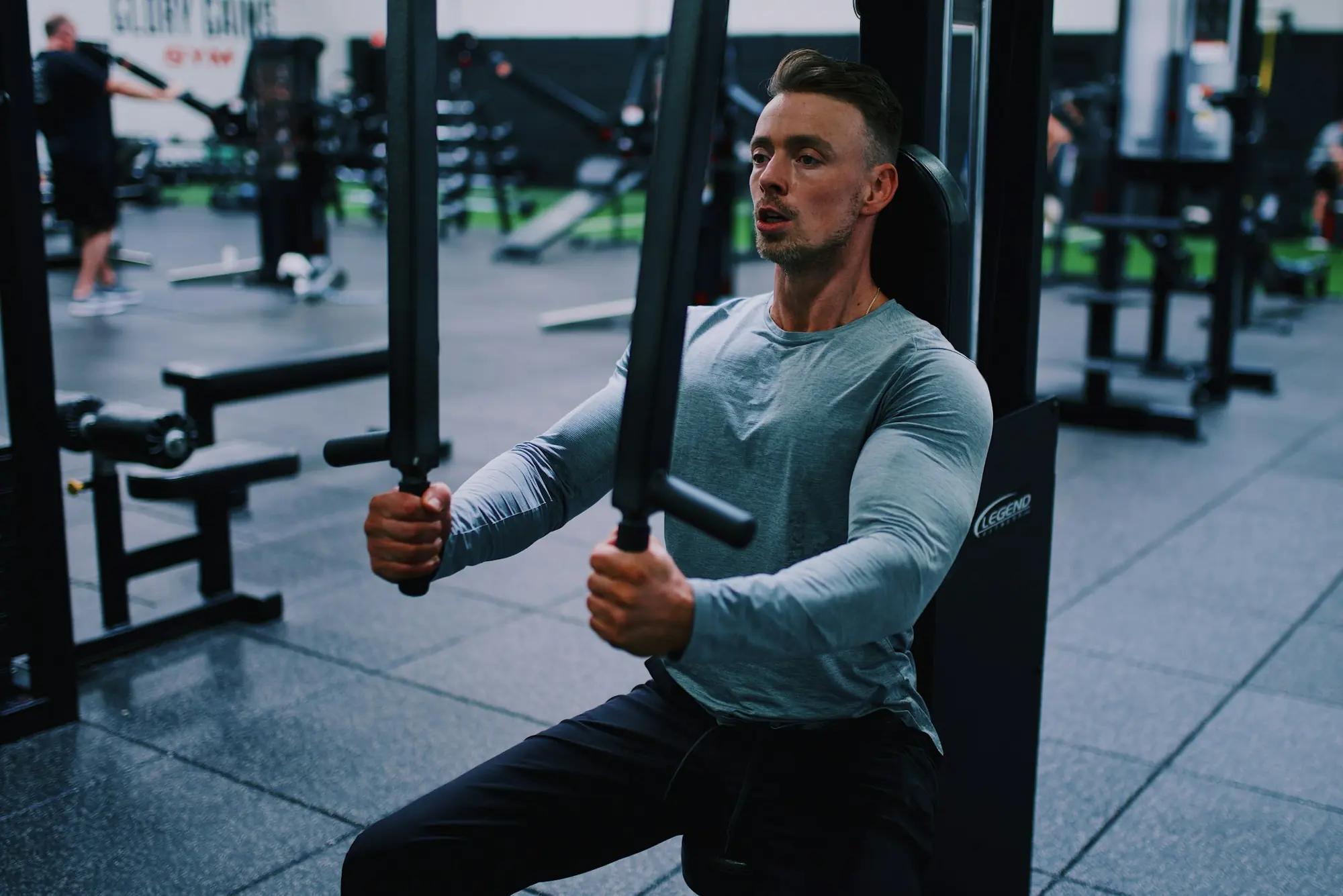 A man working a chest press machine