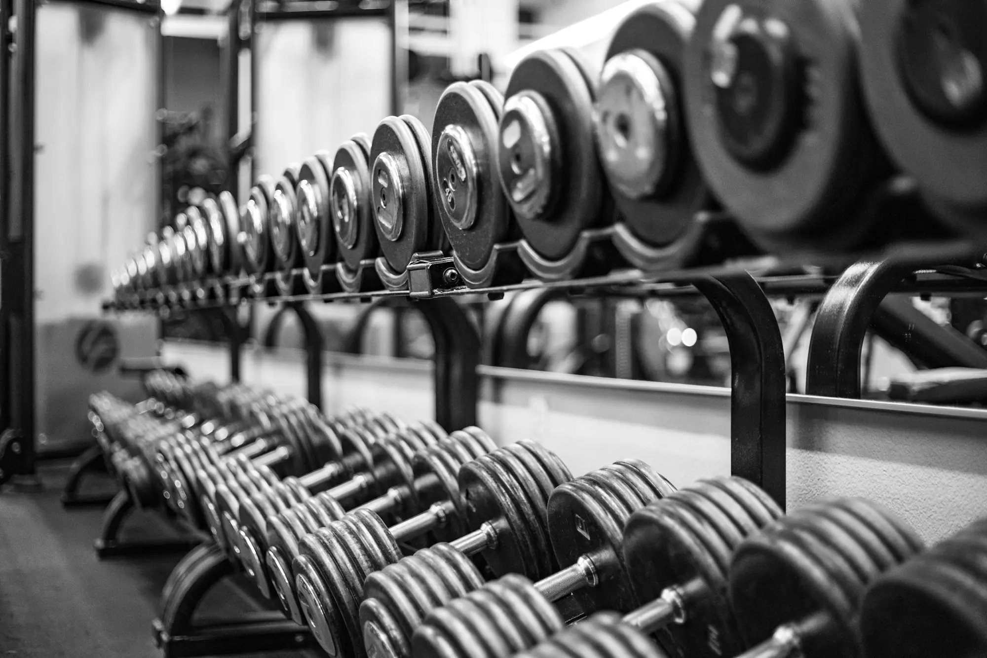 Dumbbells stacked on a rack in black and white