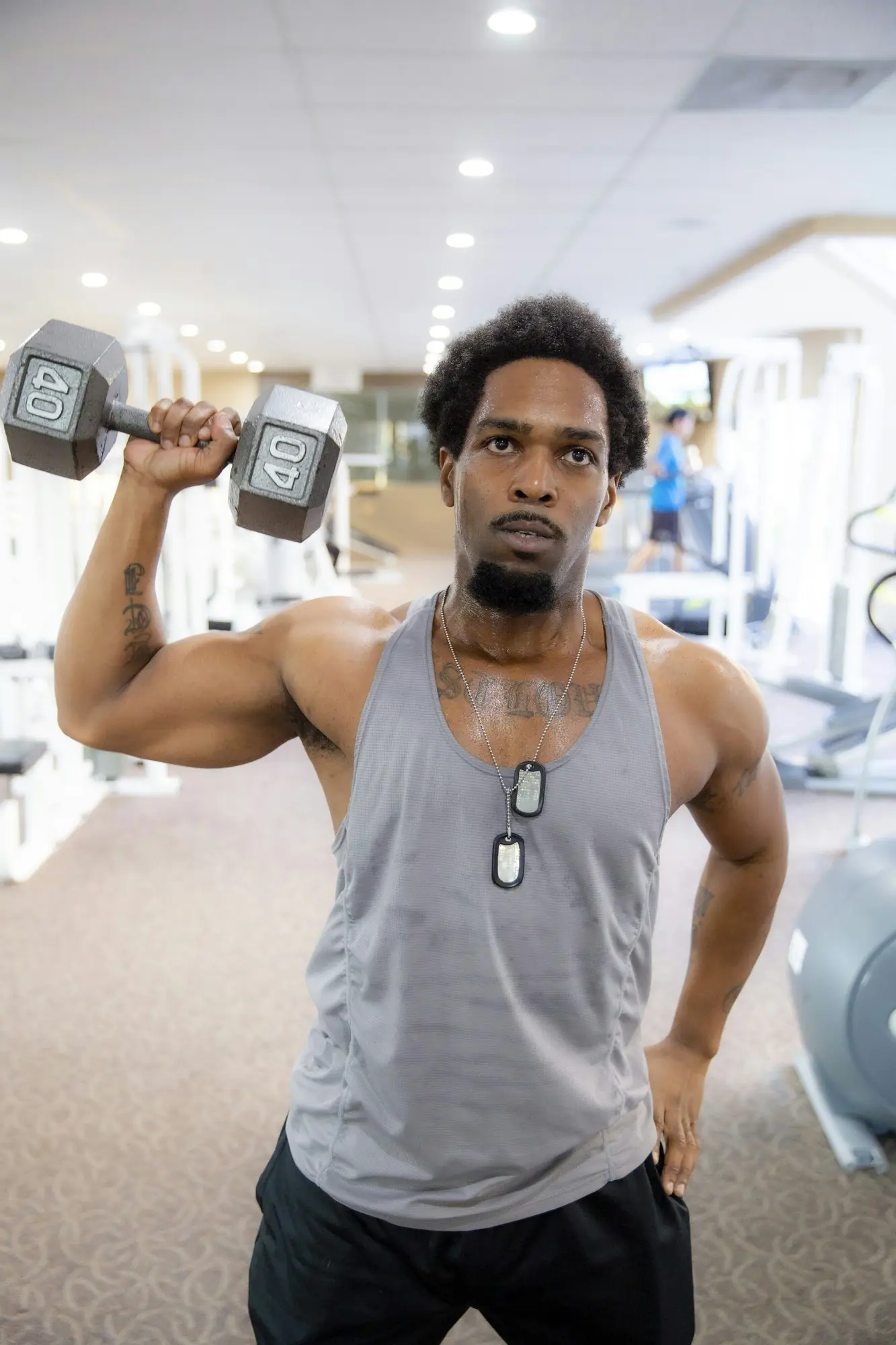 A man pressing a dumbbell overhead